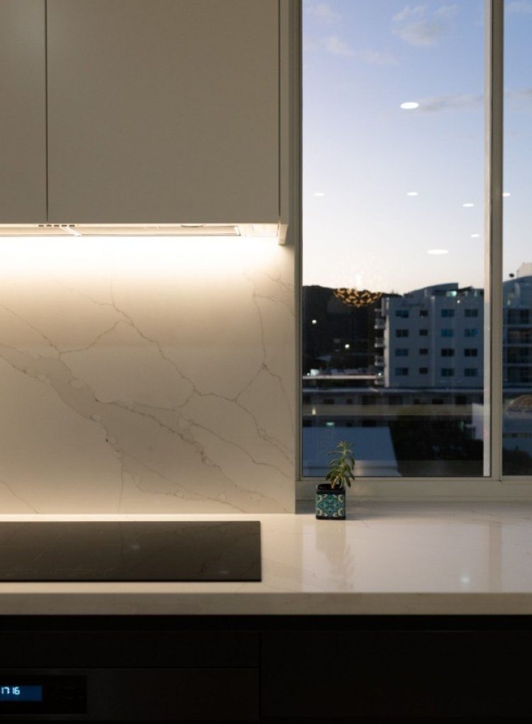 Kitchen marble splashback and under-cabinet lighting detail